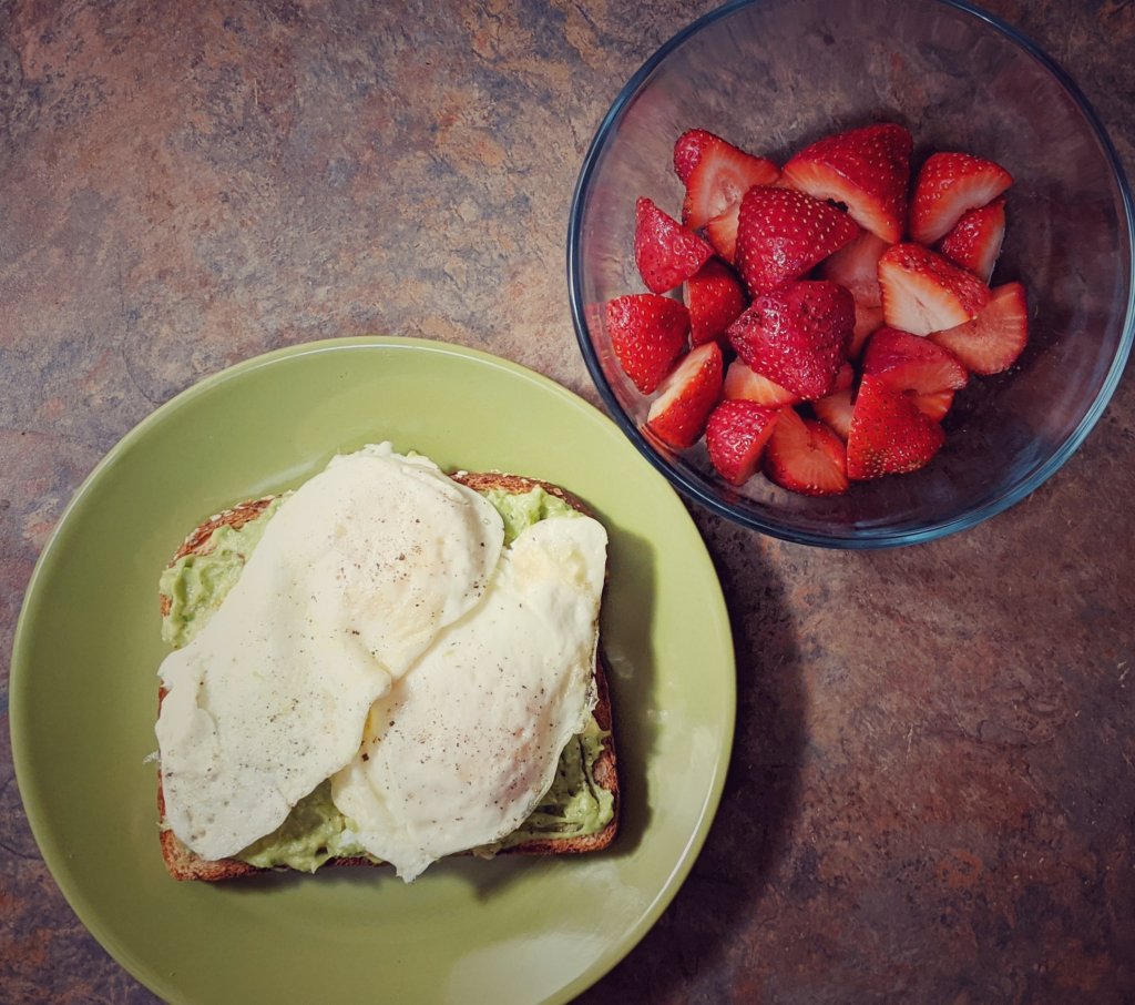avocado toast with eggs. bowl of strawberries. miss moody lilac